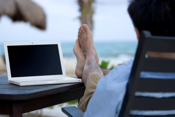 Man at Beach with Computer - Free Spaninish Translaiton made easy while in Cabo